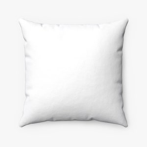 May include: Square white pillow with a textured surface. The pillow is a solid white color and has a soft, inviting appearance. The pillow is likely for home decor.