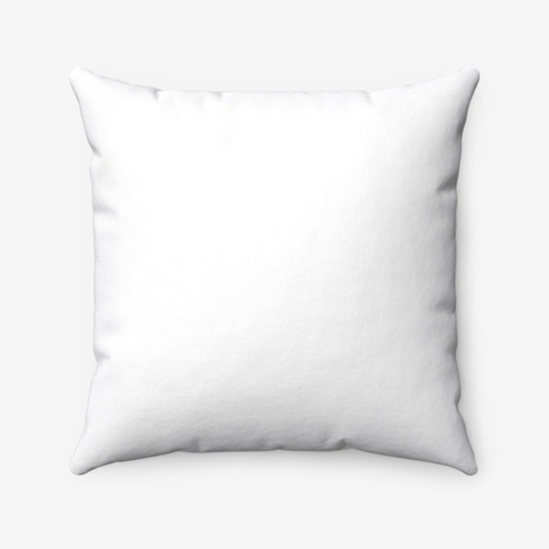 May include: Square white pillow with a textured surface. The pillow is a solid white color and has a soft, inviting appearance. The pillow is likely for home decor.