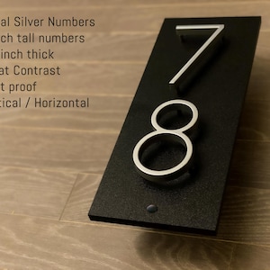 May include: Silver metal house numbers 7 and 8 on a black background. The numbers are 12.7 cm tall and 1.27 cm thick. Metal Silver Numbers 5 inch tall numbers 0.5 inch thick Great Contrast Rust proof Vertical / Horizontal