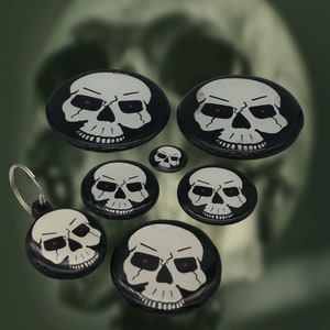 a group of skulls with red eyes on them