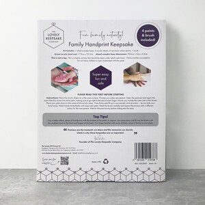 May include: Family handprint keepsake kit with a white wooden base, acrylic sheets, non-toxic paints, and a brush. The kit includes instructions and tips for creating handprints. The package features the text "Fun family activity!"
