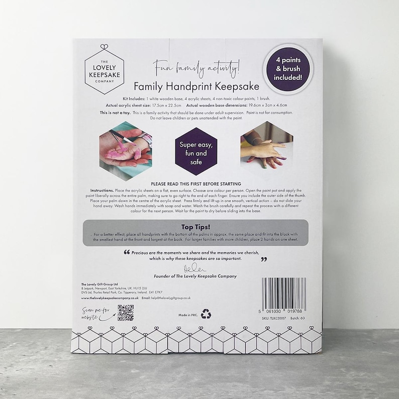 May include: Family handprint keepsake kit with a white wooden base, acrylic sheets, non-toxic paints, and a brush. The kit includes instructions and tips for creating handprints. The package features the text "Fun family activity!"