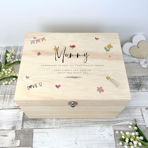May include: A rectangular light-colored wooden keepsake box with a metal latch. The lid features the text Mummy, Somewhere to keep all your special things, Love always and forever, Emily and Ethan XXX, with colorful hand-drawn style hearts, stars, flowers, and bunting.