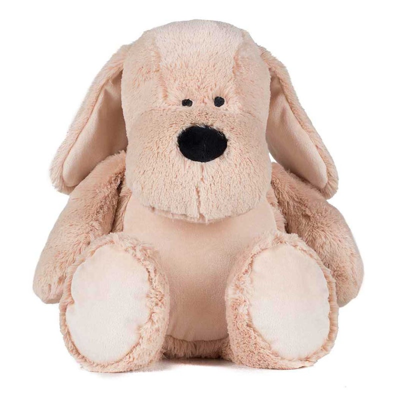 May include: A plush beige dog toy with black eyes and a black nose. The dog is sitting with its legs crossed and its ears perked up.