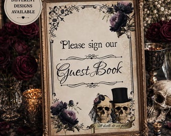 May include: A rectangular sign in an ornate gold frame featuring the text Please sign our Guest Book. The design includes dark purple floral illustrations, two skulls with a top hat and veil, and a banner with the text Till death do us part.