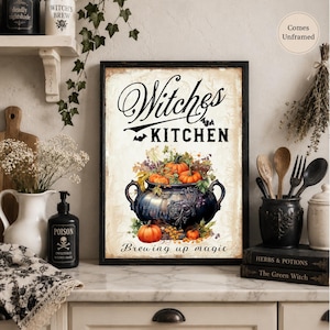 May include: A rectangular wall art print featuring the text Witches KITCHEN and Brewing up magic. The illustration depicts a dark, ornate cauldron filled with orange pumpkins and autumn foliage, accented by small black bats on a cream background.