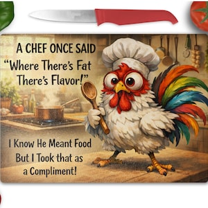 May include: A rectangular glass cutting board featuring a cartoon chicken wearing a chef hat and holding a wooden spoon. The text reads: A CHEF ONCE SAID Where There's Fat There's Flavor! I Know He Meant Food But I Took that as a Compliment!