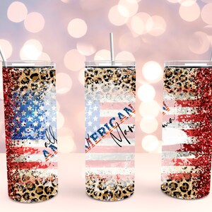 May include: Three stainless steel tumblers with a red, white, and blue American flag design with glitter and leopard print accents. The tumblers have straws and the text "All American Mom" is on one of the tumblers.