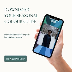 May include: A hand holding a smartphone showing a colour guide for the Dark Winter season. The screen displays a woman in a snowy scene and a palette of blues. Text on the phone reads "Your Colours Accent Colours". The image also includes the text "Download Your Seasonal Colour Guide".