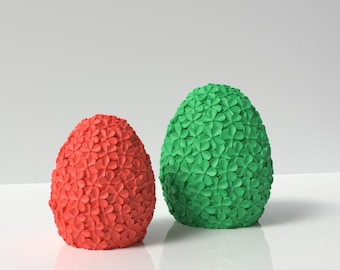 May include: Two 3D printed Easter eggs, one red and one green, with a flower pattern.