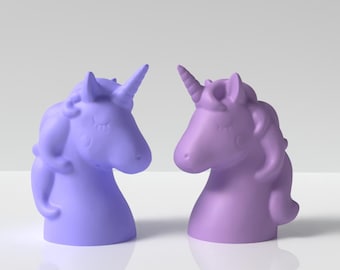 May include: Two 3D printed unicorn head figurines. One is light blue and the other is light purple. They are facing each other.