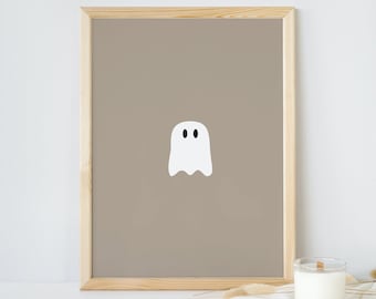 Peut inclure: Une impression encadrée avec une illustration simple de fantôme blanc sur un fond brun clair. Le cadre est en bois naturel.