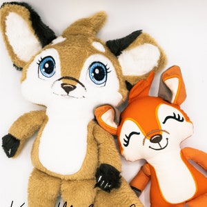 May include: A brown and white deer plush toy with big blue eyes and black hooves sits next to a smaller orange fox plush toy with black eyes and brown hooves. Both toys have embroidered smiles.