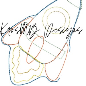 May include: A line drawing of a rocket ship in blue, yellow, orange, and green. The drawing is stylized and looks like it was created with embroidery stitches. The text "KrossMB Designs" is written in cursive at the top of the image.