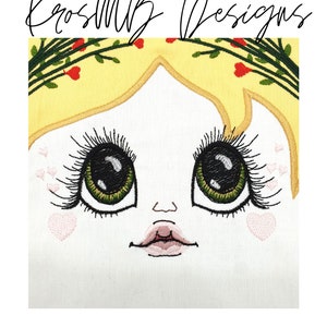 May include: Embroidered design of a girl's face with large green eyes, black eyelashes, a pink mouth, and a yellow crown of flowers.