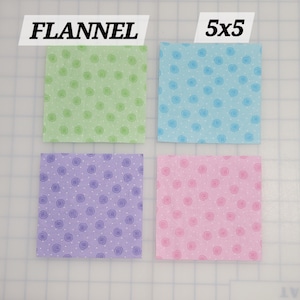 May include: Four 5x5 inch flannel fabric squares in green, blue, purple, and pink with a white swirl pattern. The fabric squares are labeled "FLANNEL" and "5x5".