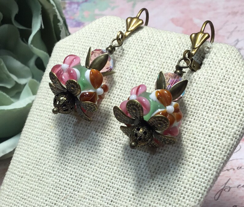 Murano lampwork pink green and rust glass beads with vintage pink crystal beads antique brass finish.