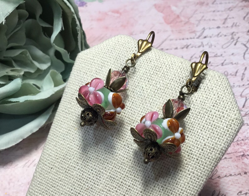 Murano lampwork pink green and rust glass beads with vintage pink crystal beads antique brass finish.