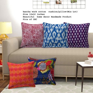 May include: Five colorful kantha stitch cotton cushion covers with various patterns. The covers are 16 inches by 16 inches and are arranged on a beige sofa. The text "kantha work cotton cushion/pillow (Mix Lot) Size 16x16 inches Beautiful home decor Handmade Product Pics of IEC" is visible in the image.