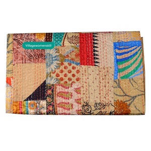 Pu&ograve; includere: Un quilt patchwork con una variet&agrave; di colori e motivi, tra cui rosso, blu, verde e marrone. Il quilt &egrave; realizzato con diversi tessuti e ha un aspetto cucito a mano. Il quilt &egrave; etichettato "Villagewomenskill".
