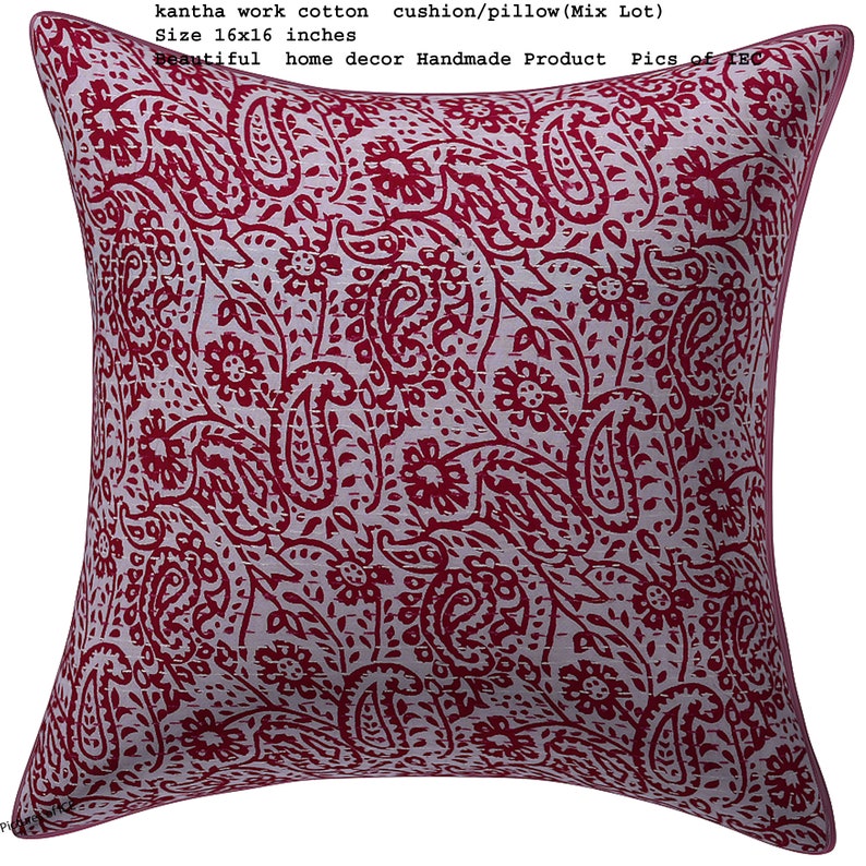May include: A red and white kantha work cotton cushion or pillow with a paisley pattern. The cushion is 16 inches by 16 inches.