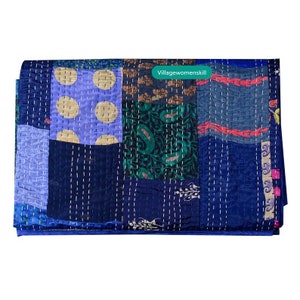 Pu&ograve; includere: Un quilt patchwork con una variet&agrave; di colori e motivi, tra cui blu, verde, giallo e rosso. Il quilt &egrave; realizzato con sari riciclati ed &egrave; cucito a mano. Il quilt &egrave; etichettato "Villagewomenskill".