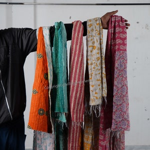 May include: A collection of colorful kantha scarves with various patterns and designs. The scarves are made of recycled saris and are perfect for adding a touch of bohemian style to any outfit.