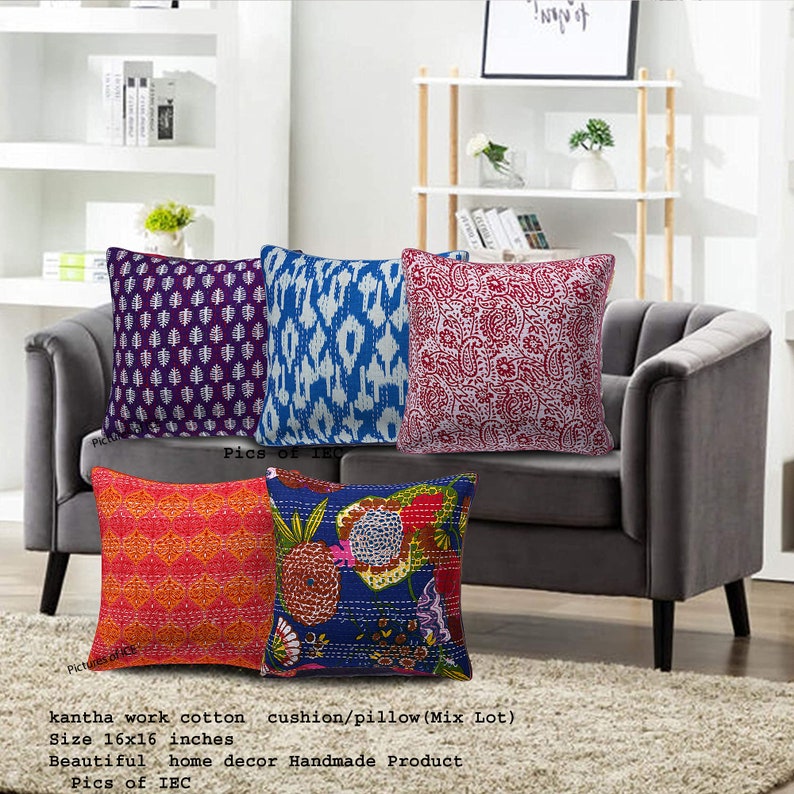 May include: Four colorful kantha work cotton cushion covers with different patterns. The covers are 16 inches by 16 inches and are handmade. The covers are displayed on a gray couch.