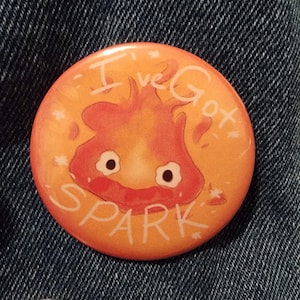 May include: A round orange button with a cartoon fire spirit with the text "I've Got Spark" in white.