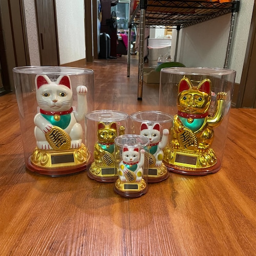 A Photo Of Maneki Neko, A Japanese Lucky Beckoning Cat Figurine, On A Figurine On A Golden Background With Copy Space Image214603020