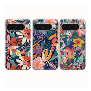 May include: Three phone cases with floral designs. The cases feature colorful flowers and leaves in various patterns. The first case has a design with orange, red, and white flowers on a navy background. The second case has pink and orange flowers on a dark blue background. The third case has pink and yellow flowers on a blue background.