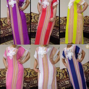 May include: Six long-sleeved striped dresses with white embroidery on the neckline. The dresses are in various colors, including purple, red, yellow, pink, white, and blue.