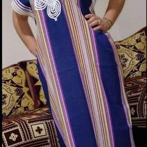 May include: A long, blue and white striped dress with a white crocheted design on the neckline.