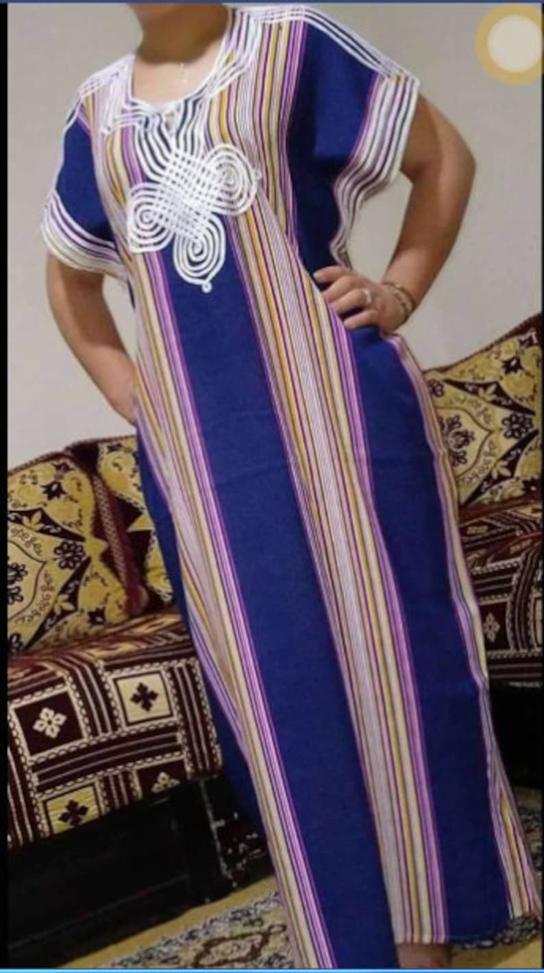 May include: A long, blue and white striped dress with a white crocheted design on the neckline.