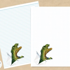 May include: A printable sheet of lined paper with a green dinosaur peeking out from the bottom of the page. The dinosaur is facing the right side of the page. The paper is white with blue lines. The dinosaur is green with a white background.