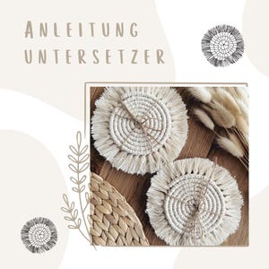 Peut inclure: Deux dessous-de-verre en crochet blanc avec des franges, sur une surface tissée. Les dessous-de-verre ont un design circulaire avec un cercle central et des anneaux concentriques.