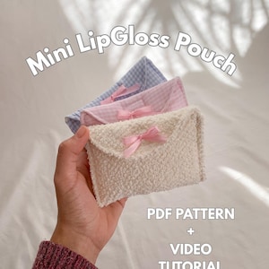 May include: Three mini lip gloss pouches in white, pink, and blue, each with a bow. The white pouch has a textured surface. Text on the image reads "Mini LipGloss Pouch" and "PDF Pattern + Video Tutorial."