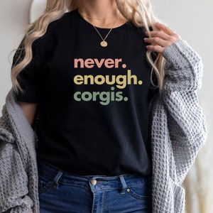 May include: A black t-shirt with the text "never. enough. corgis." in a rainbow gradient.