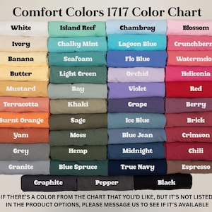 May include: A color chart for Comfort Colors 1717 apparel, featuring a variety of hues from white to black. Each color is labeled, including shades like "Chambray," "Berry," and "Espresso." The chart also includes a message about custom color requests.