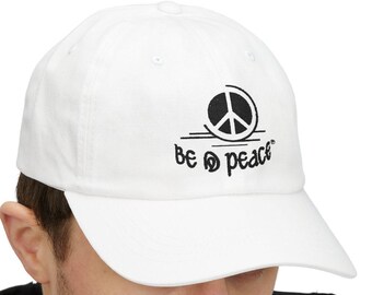 May include: White baseball cap with a curved brim. The cap features a black peace symbol and the words "Be Peace" embroidered on the front. The cap is made of a soft material and has an adjustable strap.