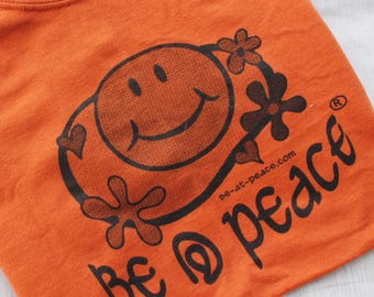 Graphic Tee Festival Clothing | Cartoon Smiley Face Shirt | Retro Hippie Unisex T-Shirt | Texas Orange