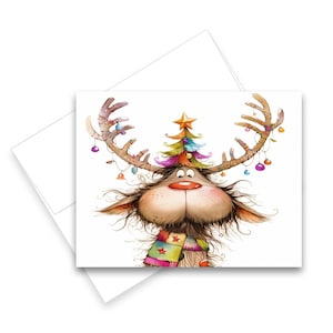 May include: A whimsical Christmas card featuring a cartoon reindeer with large antlers adorned with ornaments and a small Christmas tree. The reindeer has a red nose, a colorful scarf, and a cheerful expression. The card is on a white background.