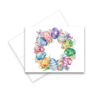May include: A watercolor painting of a wreath made of colorful Easter eggs with flowers and leaves.