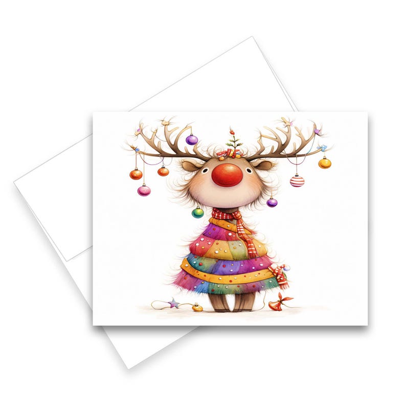 May include: A Christmas card featuring a whimsical reindeer illustration. The reindeer has large antlers adorned with colorful ornaments, a red nose, and a multi-colored dress. A matching envelope is included.