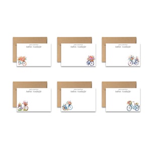 May include: Six blank note cards with brown envelopes. Each card features a watercolor illustration of a bicycle with a basket of flowers. The text "Just a note from Andrea Winchester" is printed on each card.