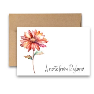 May include: A white card with a watercolor painting of a red and orange flower with green leaves. The text "A note from Ryland" is printed in gray at the bottom of the card.