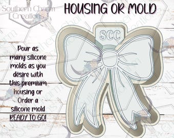May include: A bow-shaped silicone mold with the text "FRESHIE HOUSING OR MOLD" and "SCC" on the top. The text "Pour as many silicone molds as you desire with this premium housing or Order a silicone mold READY TO GO!" is also present.
