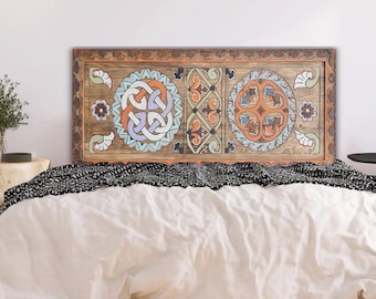 May include: A wooden headboard with a carved design featuring three circular patterns in shades of blue, green, orange, and brown. The headboard is a decorative accent for a bedroom.