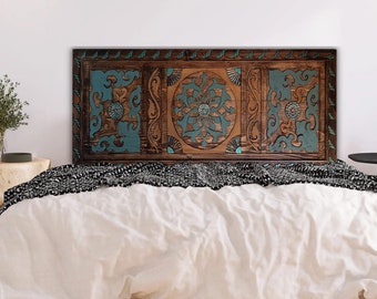 May include: A wooden headboard with a carved design featuring teal blue and brown accents. The headboard is made of wood and has a rustic look.