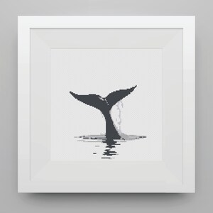 May include: A black and white cross-stitch pattern of a whale tail splashing in the water.